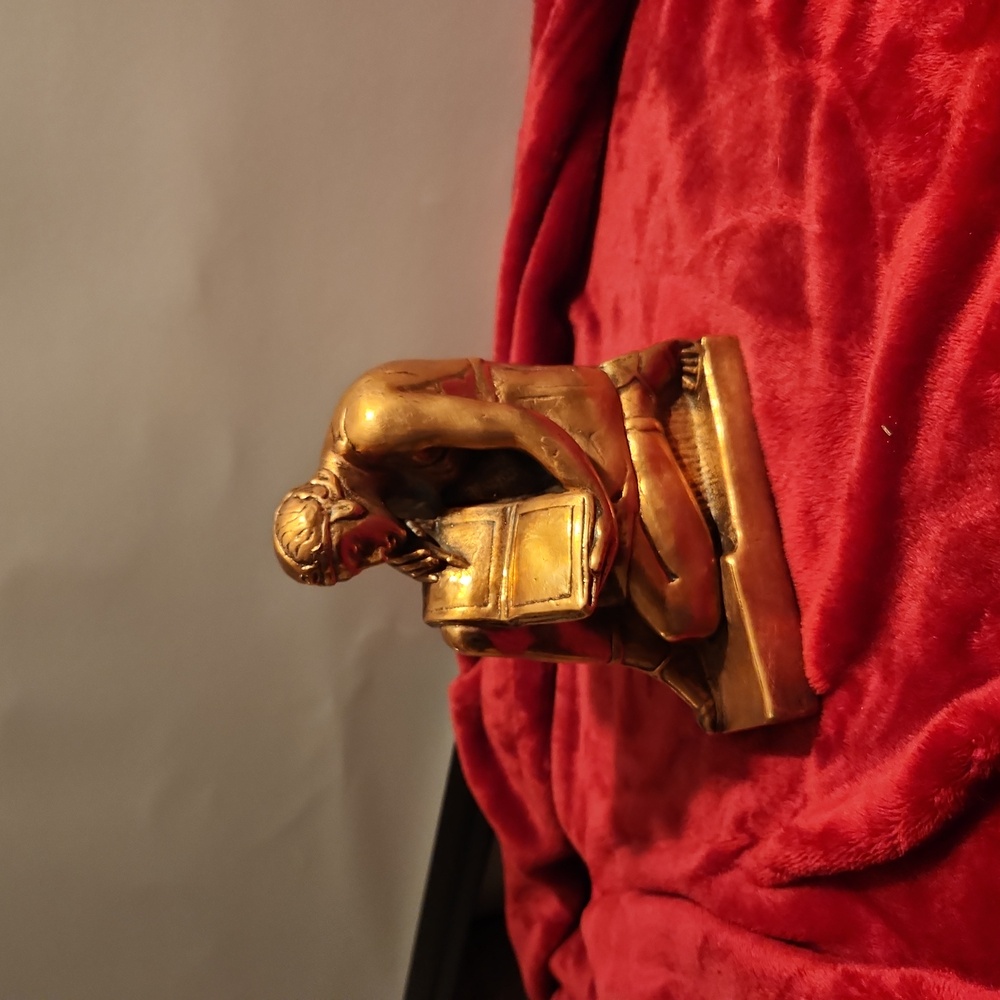 One half of bronze book end